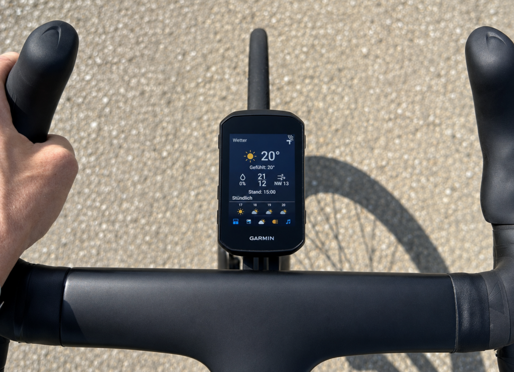 Rider's view of a Garmin Edge 850 on a bicycle handlebar. The display shows a weather overview with 20 degrees, wind and an hourly forecast.