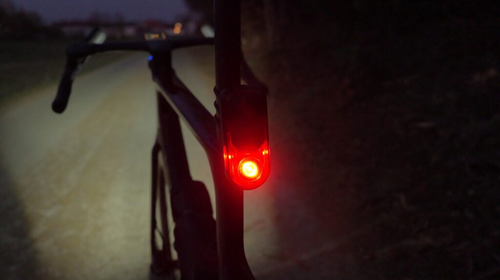 Garmin RearVue 820 Radar with a Red Rear Light on a Bike on a Dark Path at Night.