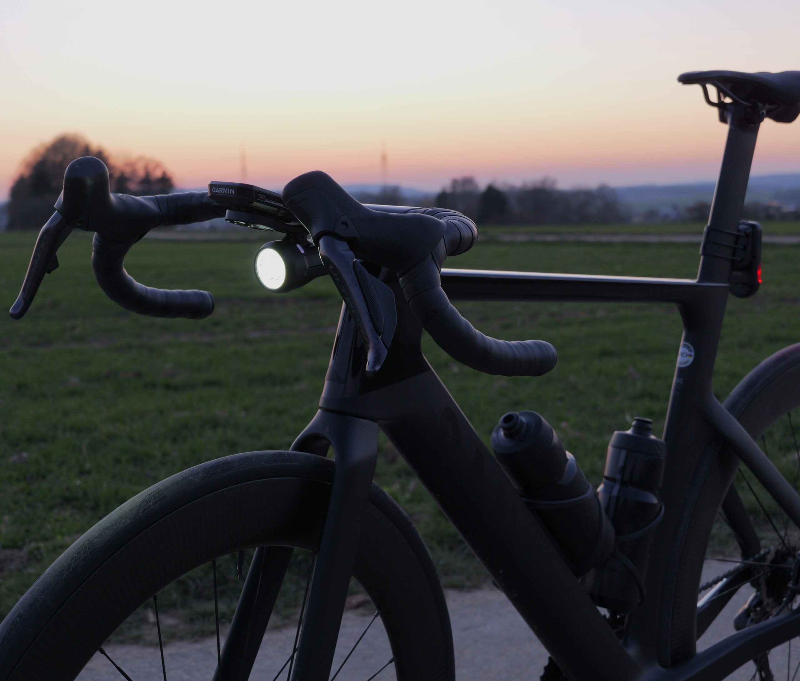 Increase road cycling visibility with a bright front light on a wet road in the dark