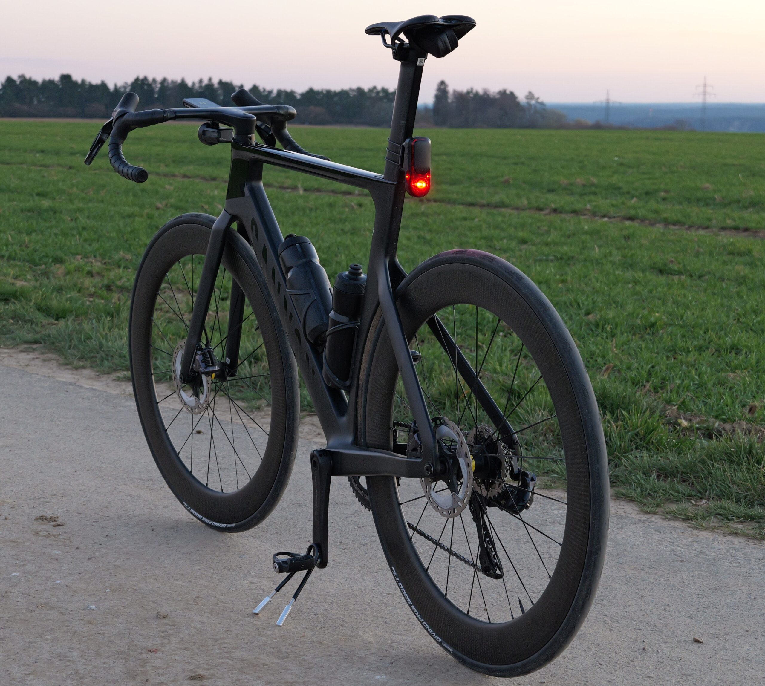 Increase road cycling visibility with a bright rear light on a wet road in the dark