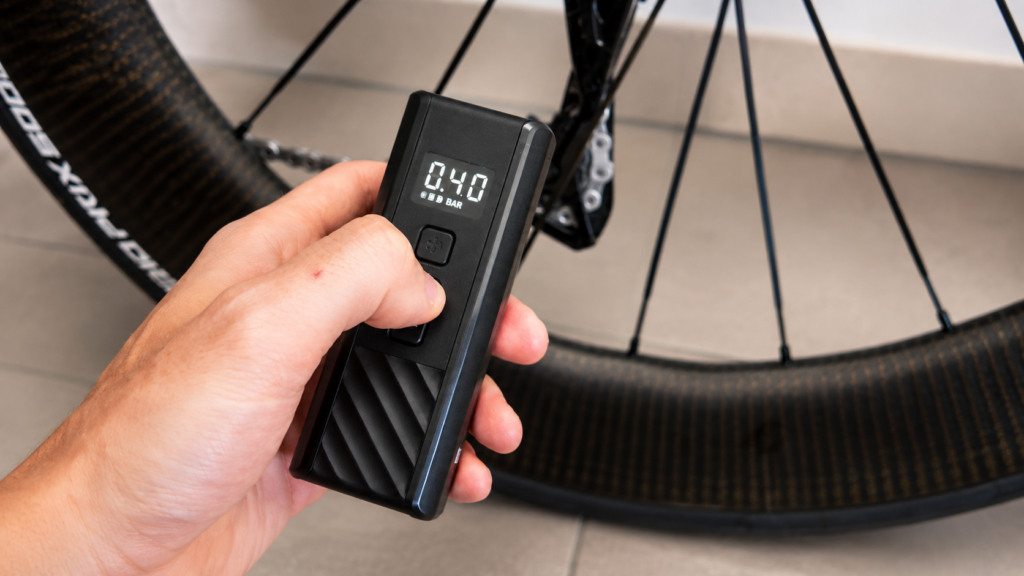 Adjusting pressure on the CYCPLUS A3 Mini with the plus and minus buttons