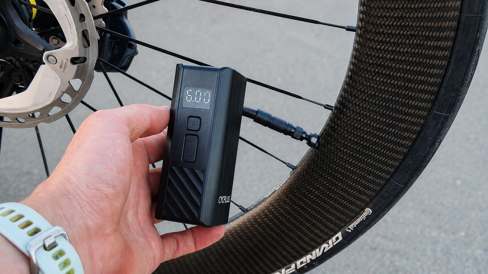 cycplus-a3-mini-electric-bike-pump CYCPLUS A3 Mini Electric Bike Pump Inflating a Road Tyre on a Carbon Wheel.