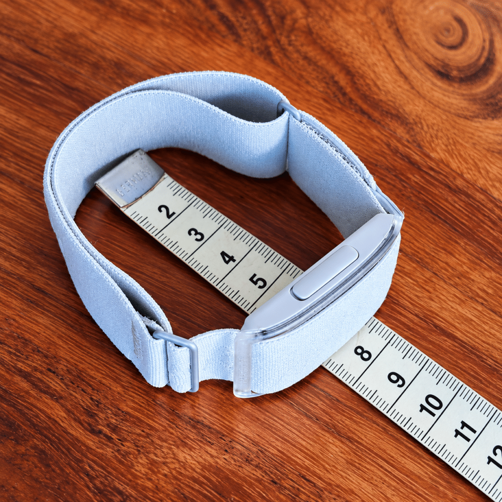 iGPSPORT HR80 Armband at Its Smallest Setting with a Tape Measure on a Wooden Table
