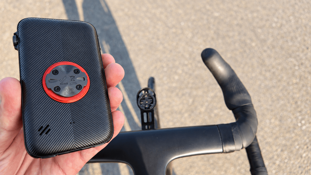 Rear of the iGPSPORT BiNavi Ultra showing its mounting fitting beside the handlebar mount